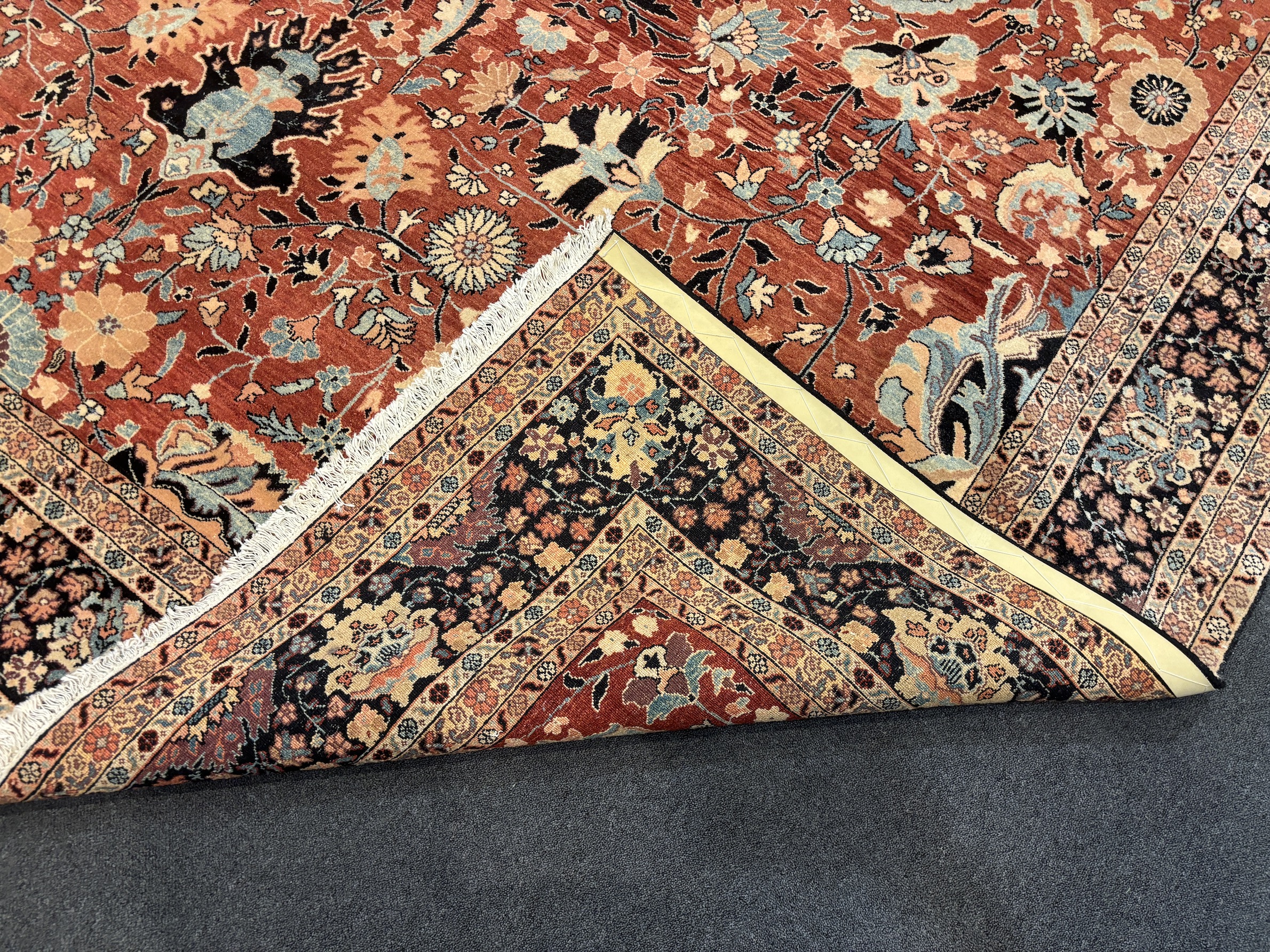 A Tabriz brick red ground gallery carpet 575 x 300cm